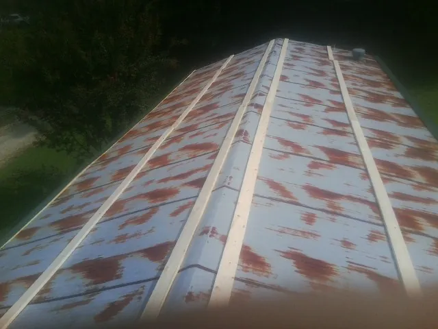 Rusted metal roof panels with new wood purlins before replacement — Storm Damage Roof Repair in Sierra Madre by Roofing Brothers
