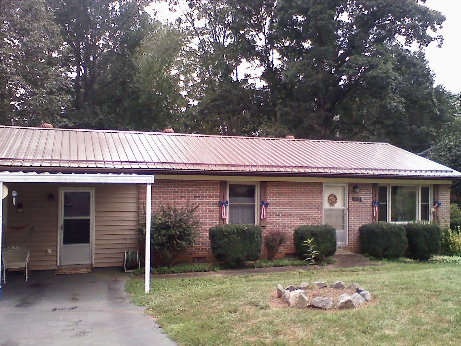 Bronze metal roof and carport on a brick ranch home — Roof Repair work by our crew in Sierra Madre